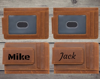 May include: Two brown leather wallets with a money clip. The wallet on the left has the name "Mike" engraved on it. The wallet on the right has the name "Jack" engraved on it.