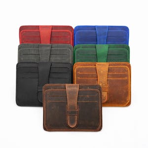 May include: A collection of leather card wallets in various colors, including red, blue, green, black, and brown. Each wallet features a secure flap closure and multiple card slots. The wallets are arranged on a white background.