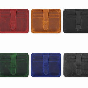 May include: A collection of six leather cardholders in various colors: red, brown, black, green, blue, and gray. Each cardholder features a flap closure with a strap and multiple card slots, ideal for carrying credit cards and IDs.