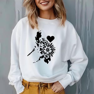 May include: White sweatshirt with a black graphic of the Philippines with flowers and a heart.