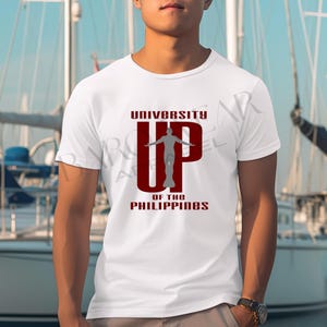 May include: White t-shirt with a red and gray graphic of a person with arms raised and the text "UNIVERSITY UP OF THE PHILIPPINES".