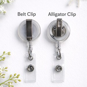 May include: Two clear plastic retractable badge holders with different clip styles. One has a belt clip, and the other has an alligator clip. Both have a clear plastic strap with a snap closure and a metal ring for attaching a badge. The text "Belt Clip" and "Alligator Clip" are above each holder.