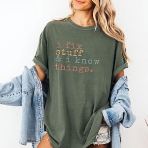 May include: A green t-shirt with the text "i fix stuff & i know things." printed in colorful letters.