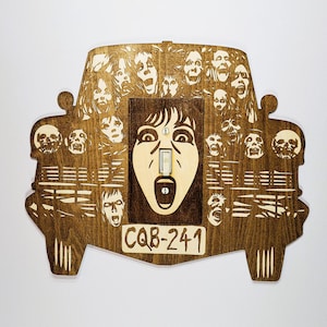 May include: A wooden light switch cover with a vintage car design. The car is filled with faces of people, and the light switch is in the center of the car. The car has the text "CQ8-241" on the front.