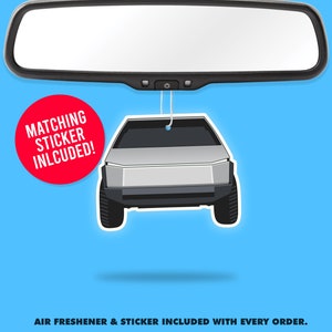 May include: A silver car air freshener hanging from a rearview mirror. The air freshener is shaped like a Tesla Cybertruck. The text "MATCHING STICKER INCLUDED!" is on a red circle.