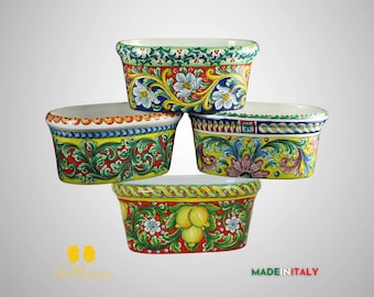 May include: Four oval ceramic planters with hand-painted floral designs in shades of yellow, green, red, and blue. The planters are stacked on top of each other. The bottom planter has a lemon design. The text "MADE IN ITALY" is visible at the bottom of the image.
