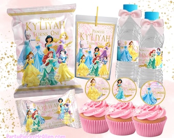 May include: Princess themed party supplies featuring a pink and gold color scheme. The set includes a chip bag, a candy bar wrapper, cupcake toppers, water bottle labels, and a favor bag. The labels feature a variety of Disney princesses, including Cinderella, Belle, Ariel, and Jasmine. The text on the labels reads "Princess Ky'Liyah Turns One".
