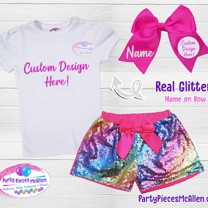 May include: A white t-shirt with a pink "Custom Design Here!" text overlay. A pair of rainbow sequin shorts with a pink bow. A pink bow with the word "Name" on it. The text "Real Glitter! Name on Bow" is also visible.