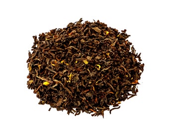 May include: A close-up of a pile of loose leaf black tea with small pieces of orange peel. The tea is dark brown and has a slightly reddish hue.