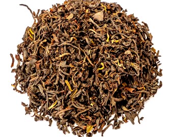 May include: A pile of loose leaf black tea with a dark brown color. The tea leaves are dried and curled.