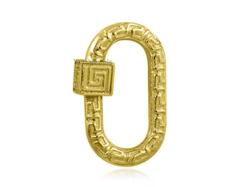 May include: Gold-toned metal clasp with a Greek key pattern. The clasp is oval-shaped and has a square-shaped latch with a Greek key pattern.