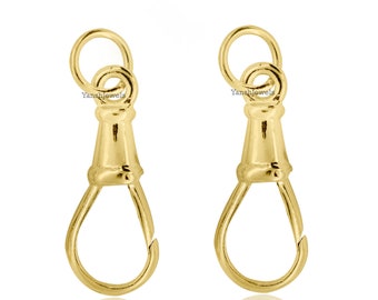 May include: Two gold-tone metal clasps with a loop at the top and a hook at the bottom. The clasps are designed to attach to a chain or other jewelry.