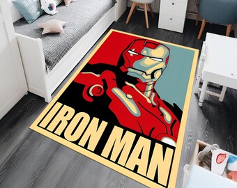 May include: A yellow, red, and black area rug with a graphic of Iron Man's face and the text "IRON MAN".