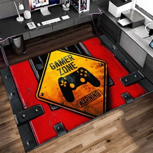 Peut inclure: Un panneau d'avertissement de zone de jeu rouge et jaune avec une manette de jeu vidéo noire sur un fond rouge et noir.