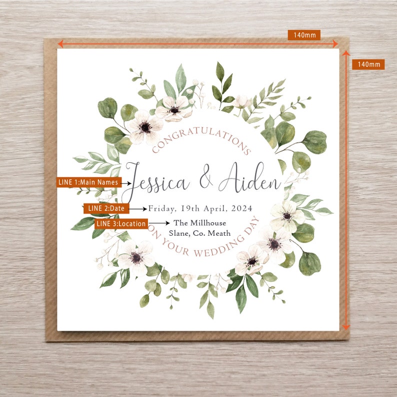 May include: A square wedding card measuring 140mm by 140mm featuring a watercolour floral wreath of green leaves and white flowers. The text reads: CONGRATULATIONS, Jessica & Aiden, Friday, 19th April, 2024, The Millhouse, Slane, Co. Meath, ON YOUR WEDDING DAY.