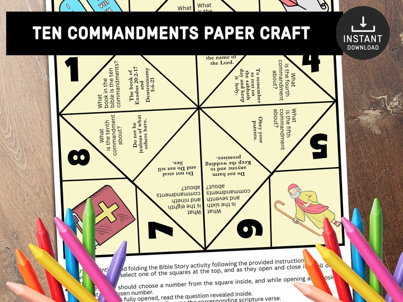 May include: A printable paper craft activity for kids to learn about the Ten Commandments. The paper craft is shaped like a fortune teller or cootie catcher. The paper craft has the text "Ten Commandments Paper Craft" at the top and the text "Instant Download" in the upper right corner. The paper craft is divided into eight sections, each with a question about the Ten Commandments. The paper craft is on a wooden surface with colored pencils.