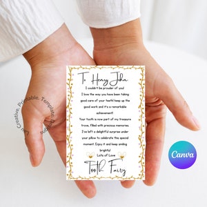 May include: A white card with gold and pink floral borders and gold lettering. The card reads "To Henry John I couldn't be prouder of you! I love the way you have been taking good care of your teeth! Keep up the good work and it's a remarkable achievement! Your tooth is now part of my treasure trove, filled with precious memories. I've left a delightful surprise under your pillow to celebrate this special moment. Enjoy it and keep smiling brightly! Lots of Love Tooth Fairy"