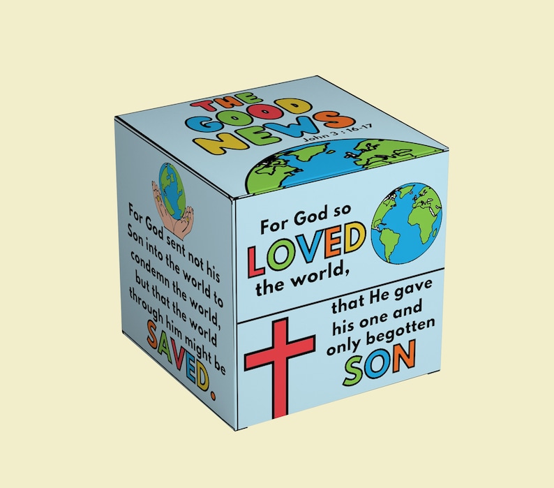 May include: A blue cube with the words "The Good News" in colorful letters. The cube has a red cross and a world map on it. The text "For God so loved the world, that He gave his one and only begotten Son" is written on the cube.