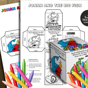 Pode incluir: Um kit de artesanato imprimível intitulado "Jonas e o Grande Peixe" com ilustrações coloridas e texto. O kit inclui instruções, um modelo em forma de cubo e páginas para colorir. Lápis de cor em várias cores estão espalhados.