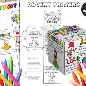 May include: A printable Advent prayer cube for kids. The cube features colorful illustrations of a dove, snowman, and a person with a halo. Each side of the cube has a different prayer, such as "Heavenly Father, bring peace to our hearts and our world. Amen." and "Dear God, as Christmas comes closer, fill our hearts with joy. Amen."