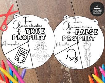May include: Two white circular educational charts with the text "Five Characteristics of a TRUE PROPHET" and "Five Characteristics of a FALSE PROPHET". The charts have illustrations and text. Colored pencils and scissors are also visible.