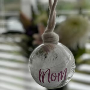 Glass bauble with feather and name personalised. Memorial gift to remember a loved one