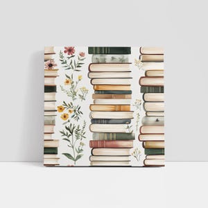 May include: A square canvas print featuring a repeating pattern of stacked books in various colors, including green, brown, and tan. Delicate floral illustrations with yellow and pink flowers and green leaves are interspersed between the book stacks.