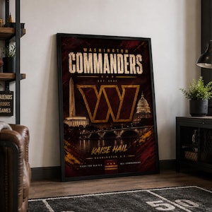 May include: A framed vertical poster featuring the Washington Commanders logo in gold and burgundy. The design includes the Washington Monument, the U.S. Capitol, and the text "WASHINGTON COMMANDERS", "EST. 1932", "RAISE HAIL", and "WASHINGTON D.C."