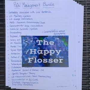 May include: A handwritten list of pain management topics, including terminology associated with local anesthesia, maxillary injections, dosage calculations, and vasoconstrictor dose calculations. The list is on a white sheet of paper with blue ink. The paper is partially covered by a blue and white floral pattern with the text "The Happy Flosser" in black.