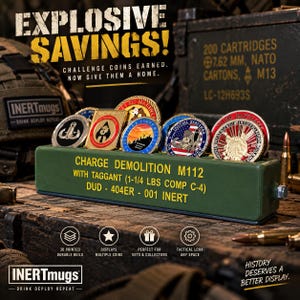 May include: An olive green rectangular display stand for challenge coins, featuring yellow text that reads: CHARGE DEMOLITION M112 WITH TAGGANT (1-1/4 LBS COMP C-4) DUD - 404ER - 001 INERT. The stand holds five circular metal coins with various colorful emblems.