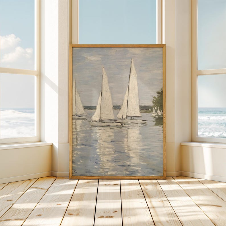 May include: A framed painting of sailboats on a body of water. The artwork features three sailboats with white sails, reflecting in the water. The sky is a pale blue, and the painting is in a wooden frame. The scene evokes a sense of tranquility.