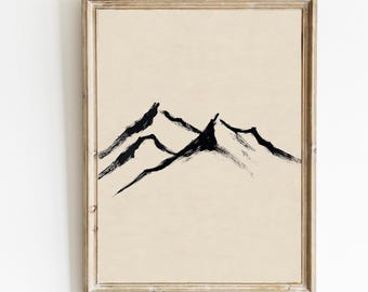Puede incluir: Una impresión de arte minimalista en blanco y negro enmarcada de una cordillera. Las montañas están pintadas con un efecto de pinceladas sobre un fondo beige.