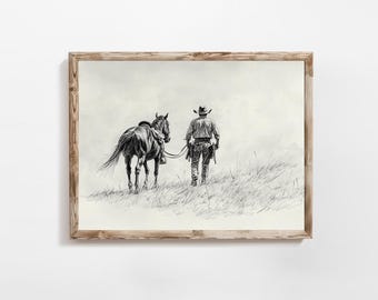 May include: Black and white sketch of a cowboy walking away from the viewer, leading a saddled horse through tall grass. The artwork is framed in a light brown wooden frame, creating a rustic aesthetic.