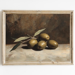May include: An antique-style framed print featuring a still life of olives. The painting depicts five green olives with a sprig of leaves, set against a muted brown and beige background. The artwork is presented in a vintage-style wooden frame.