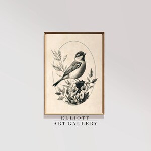Puede incluir: Ilustración en blanco y negro de un pájaro posado en una rama con flores. La imagen está enmarcada y tiene el texto "ELLIOTT ART GALLERY" en la parte inferior.