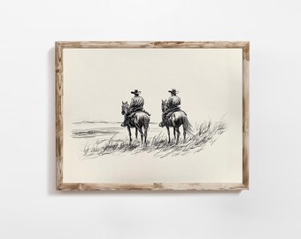 Puede incluir: Un boceto en blanco y negro enmarcado representa a dos vaqueros a caballo, vistos desde atrás, con vistas a un paisaje. La obra de arte está sobre un fondo crema, enmarcada en un marco de madera rústica.