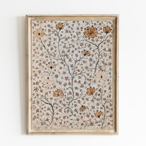 May include: A framed print of a vintage floral design with a beige background and brown and orange flowers. The frame is a light wood colour.