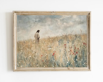 May include: Framed art print depicting a figure in a long robe walking through a field of wildflowers. The artwork has a muted color palette with beige, blue, and red tones. The frame is a light wood color.