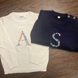 Floral embroidered initial sweaters
