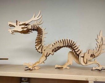 May include: A wooden dragon sculpture with intricate details, assembled from multiple pieces. The dragon is posed in a dynamic, coiled position with its head raised and its tail curled.