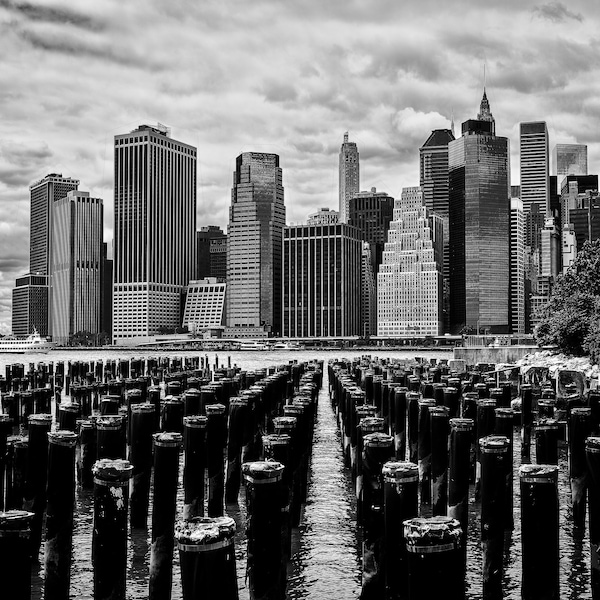 Downtown Manhattan Skyline from Brooklyn with pier pylons in foreground-Black and White