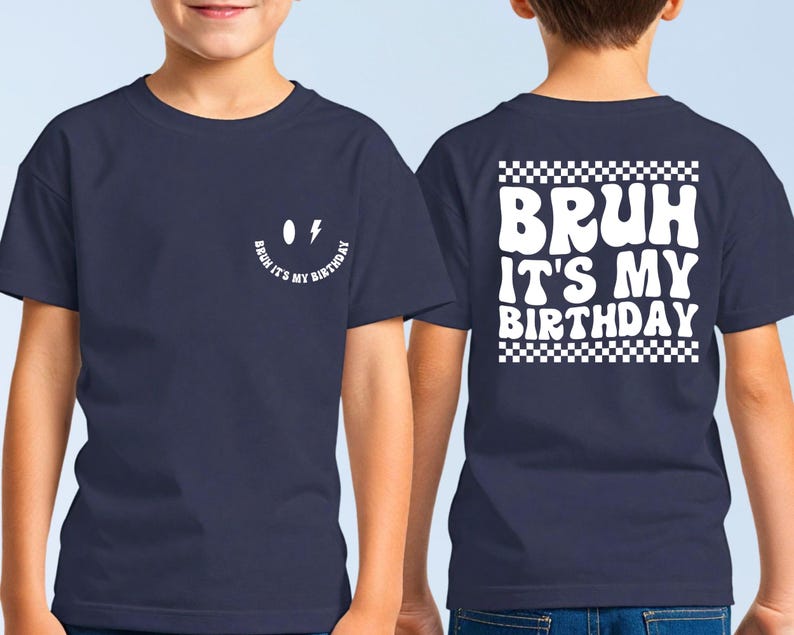 May include: A navy blue t-shirt with a white smiley face and the text "Bruh it's my birthday" on the front. The back of the shirt has the text "Bruh it's my birthday" in a white checkered box.