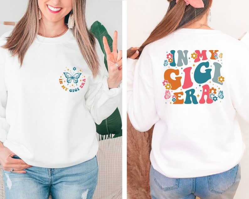 May include: White sweatshirt with a butterfly and the text "In My Gigi Era" on the front and the text "In My Gigi Era" in large, colorful letters on the back.
