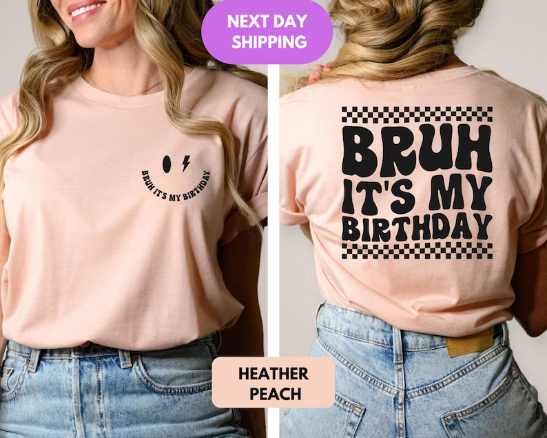 May include: A light pink t-shirt with a black smiley face and the text "Bruh it's my birthday" on the front. The back of the shirt has the text "Bruh it's my birthday" in a retro font with a black and white checkered pattern.