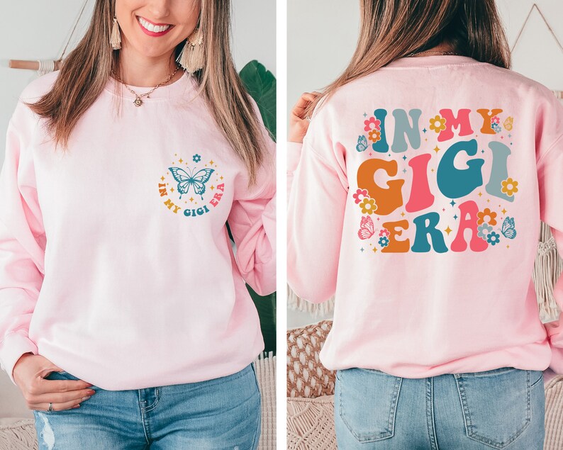 May include: Pink sweatshirt with a butterfly and the text "In My Gigi Era" on the front and the same text in larger, colorful letters on the back.