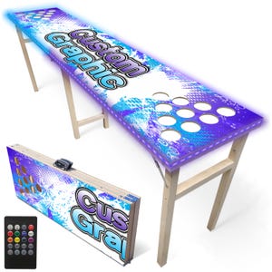May include: A custom graphic beer pong table with a blue and purple design and LED lights. The table has a folding design and includes a remote control. The text "Custom Graphic" is displayed on the table.