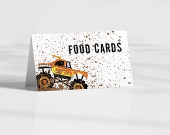 May include: A white card with a monster truck graphic and the text "FOOD CARDS" printed in black. The monster truck is orange and yellow with black wheels and is driving through mud.