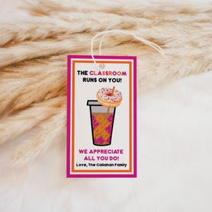 May include: Pink and white gift tag with a donut and coffee cup graphic. The text reads "The classroom runs on you! We appreciate all you do! Love, The Callahan Family."