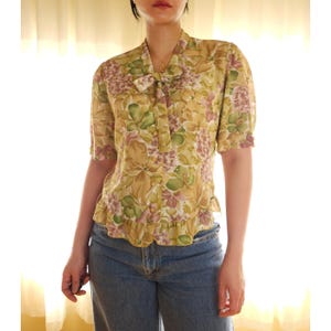 Vintage short sleeve floral ruffle hem bow tie neck button up blouse