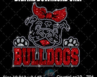 May include: A digital download graphic featuring a bulldog design. The bulldog is adorned with sparkling rhinestones, a red bow, and the word "BULLDOGS" in red rhinestones. The image is on a black background and measures 10.063 x 9.647 inches.